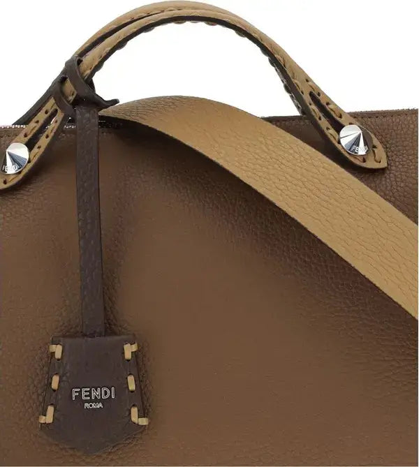 Brown leather handbag with gold accents and Fendi logo tag on a white background