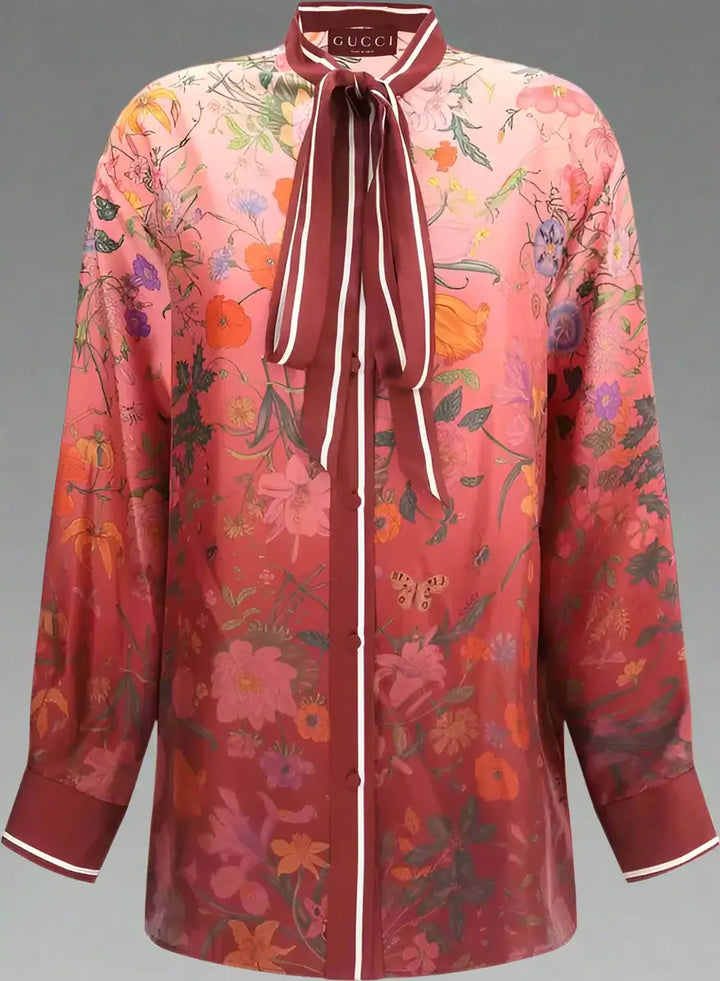 Floral patterned blouse with a tie collar on a white background