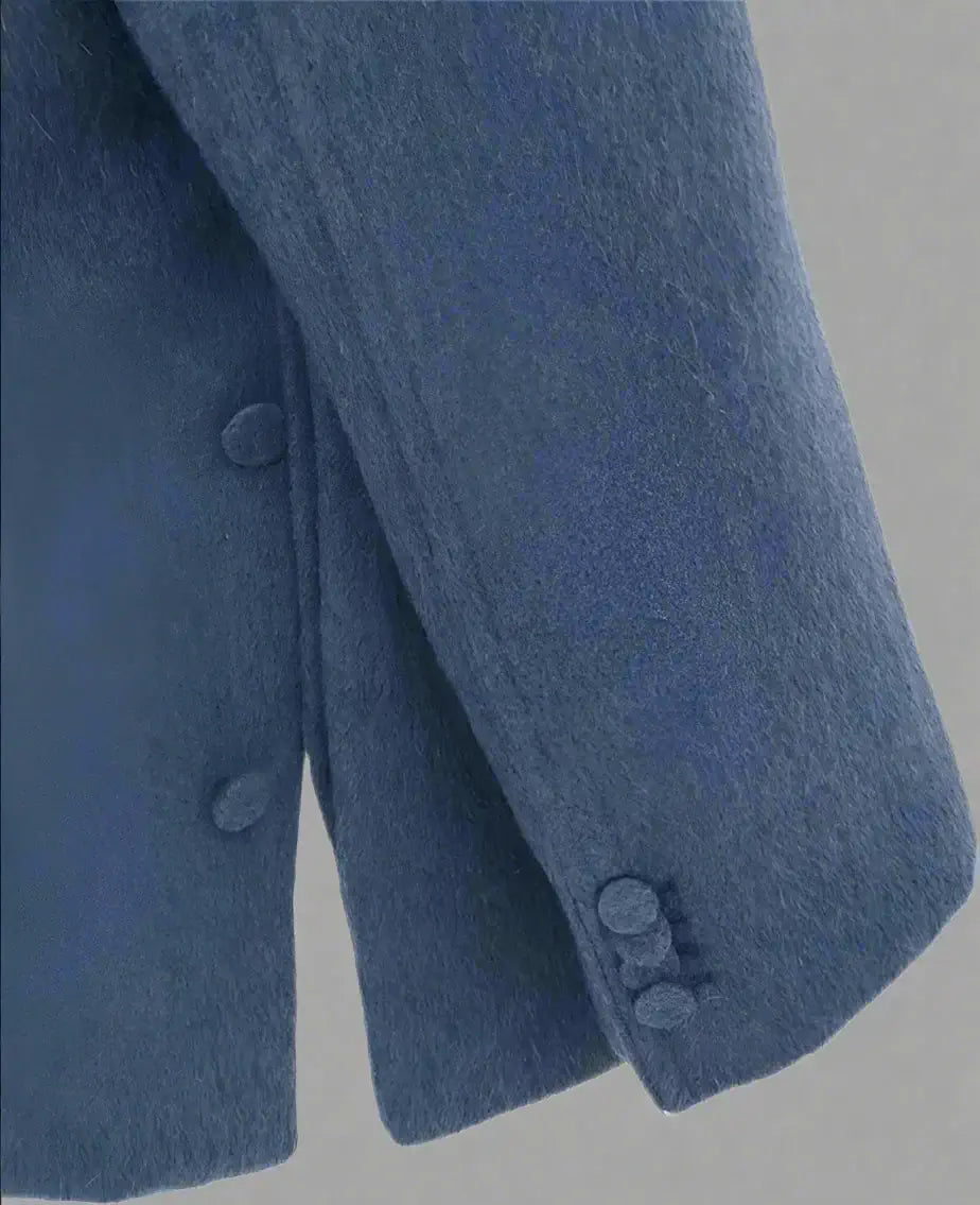 Close-up of a blue coat with buttons on a white background