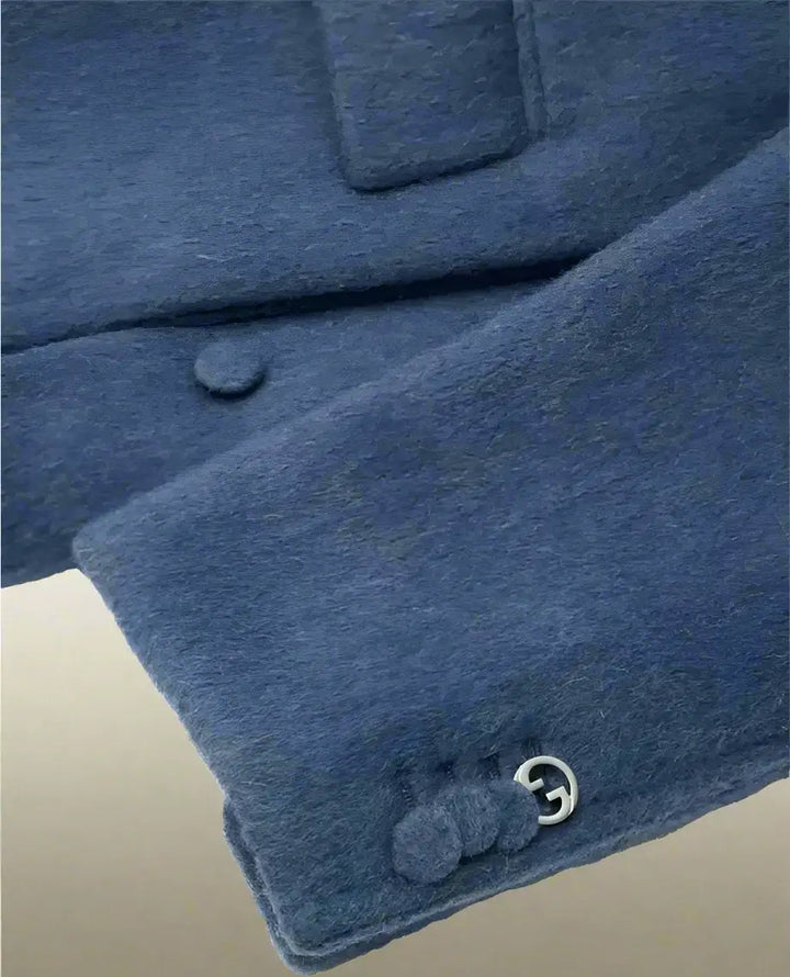 Close-up of a blue garment with buttons on a white background