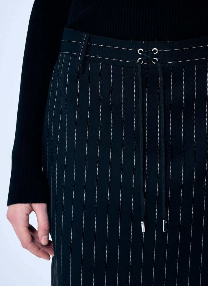 Black pinstripe skirt with a close-up of the waistband on a white background