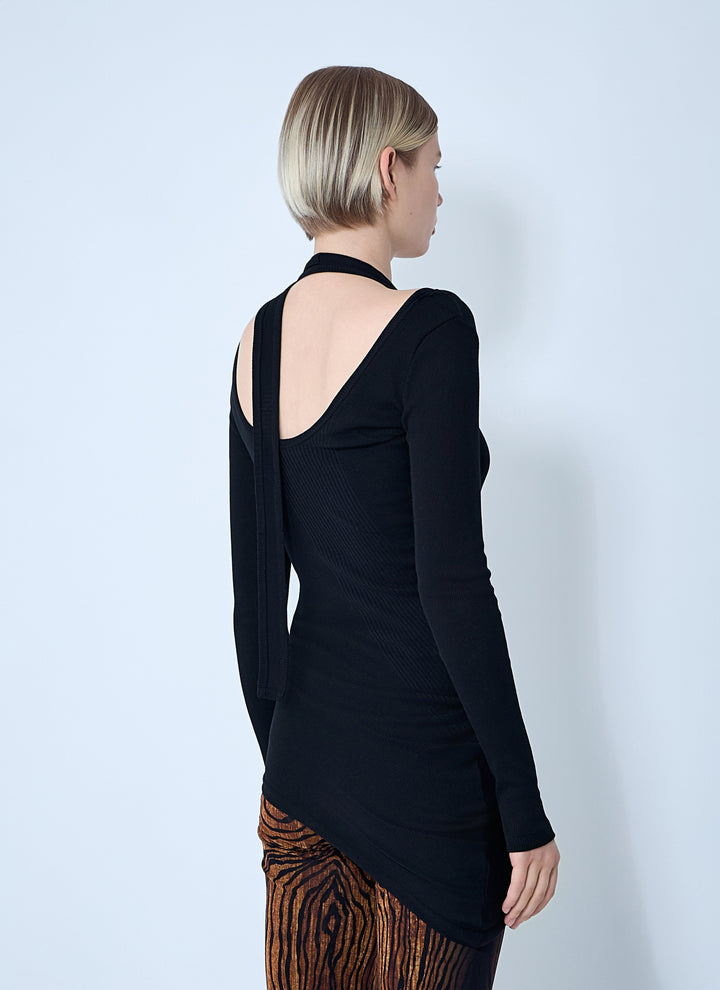 Person wearing a black long-sleeve top with cut-out design on a white background