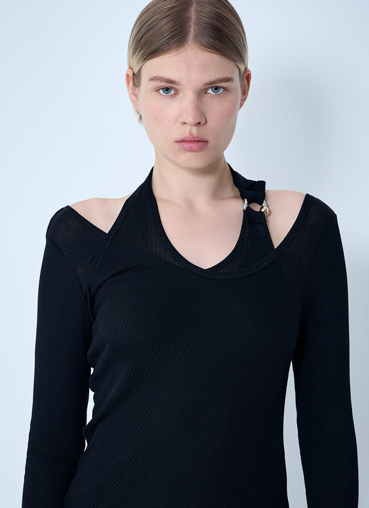 Woman wearing a black off-shoulder top against a light blue background