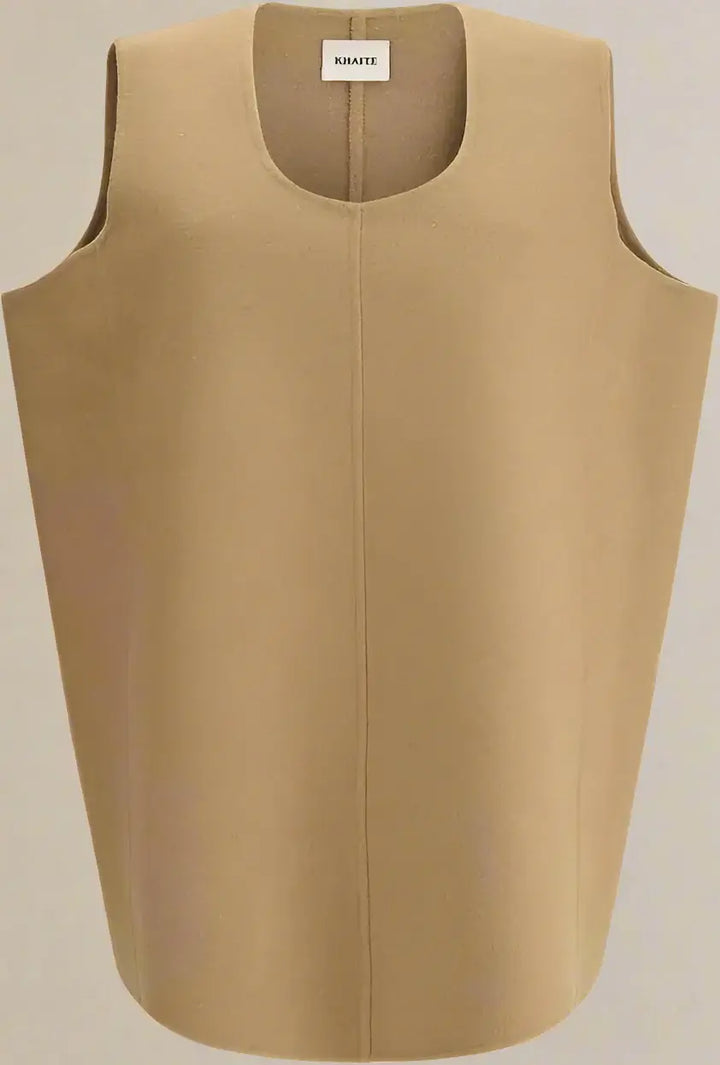 Beige sleeveless top with a brand label on a white background