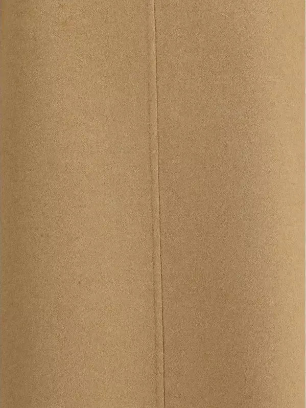 Close-up of a textured beige fabric with a visible seam.