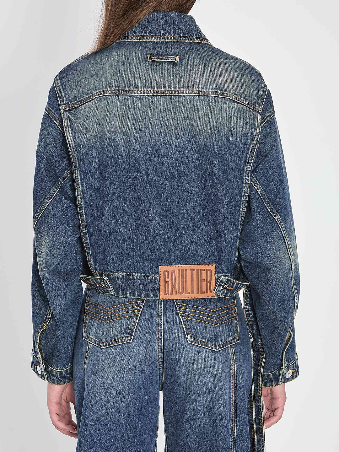 Denim jacket with 'Gaultier' label on a white background