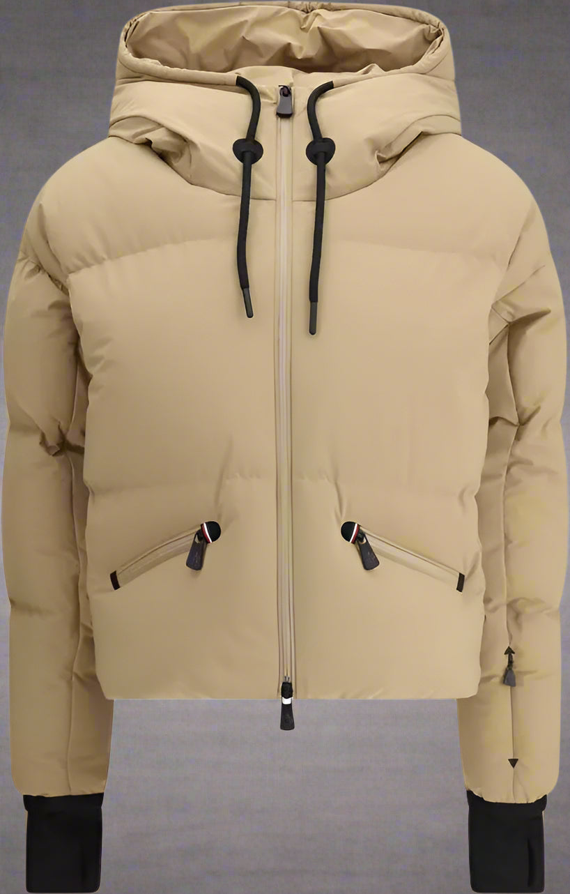 Beige puffer jacket with black zippers on a white background