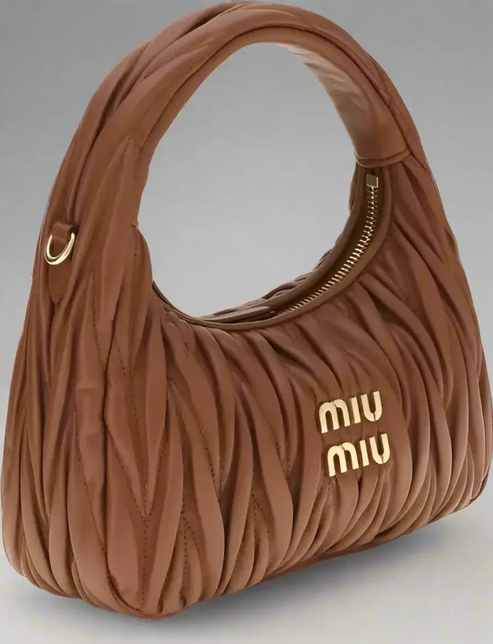 Brown handbag with 'Miu Miu' logo on a white background