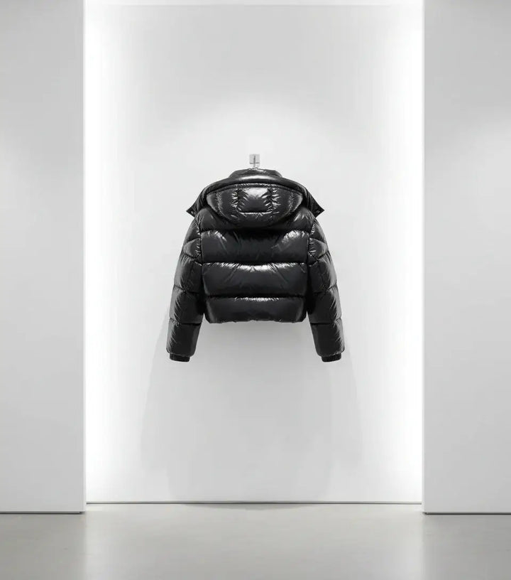Black puffer jacket on a white background