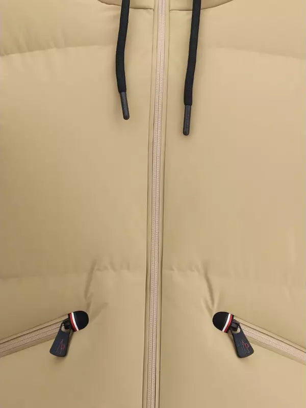 Close-up of a beige jacket with a zipper and black zippers on the cuffs.