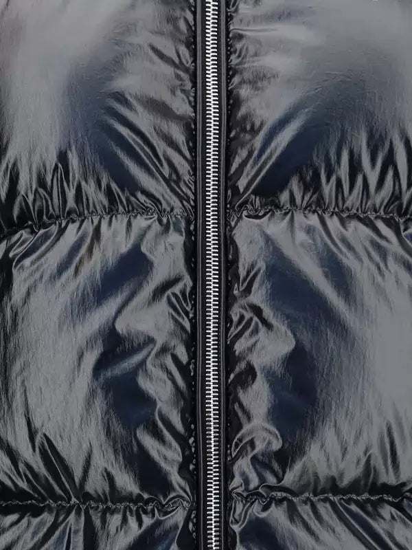 Close-up of a black puffer jacket with a zipper
