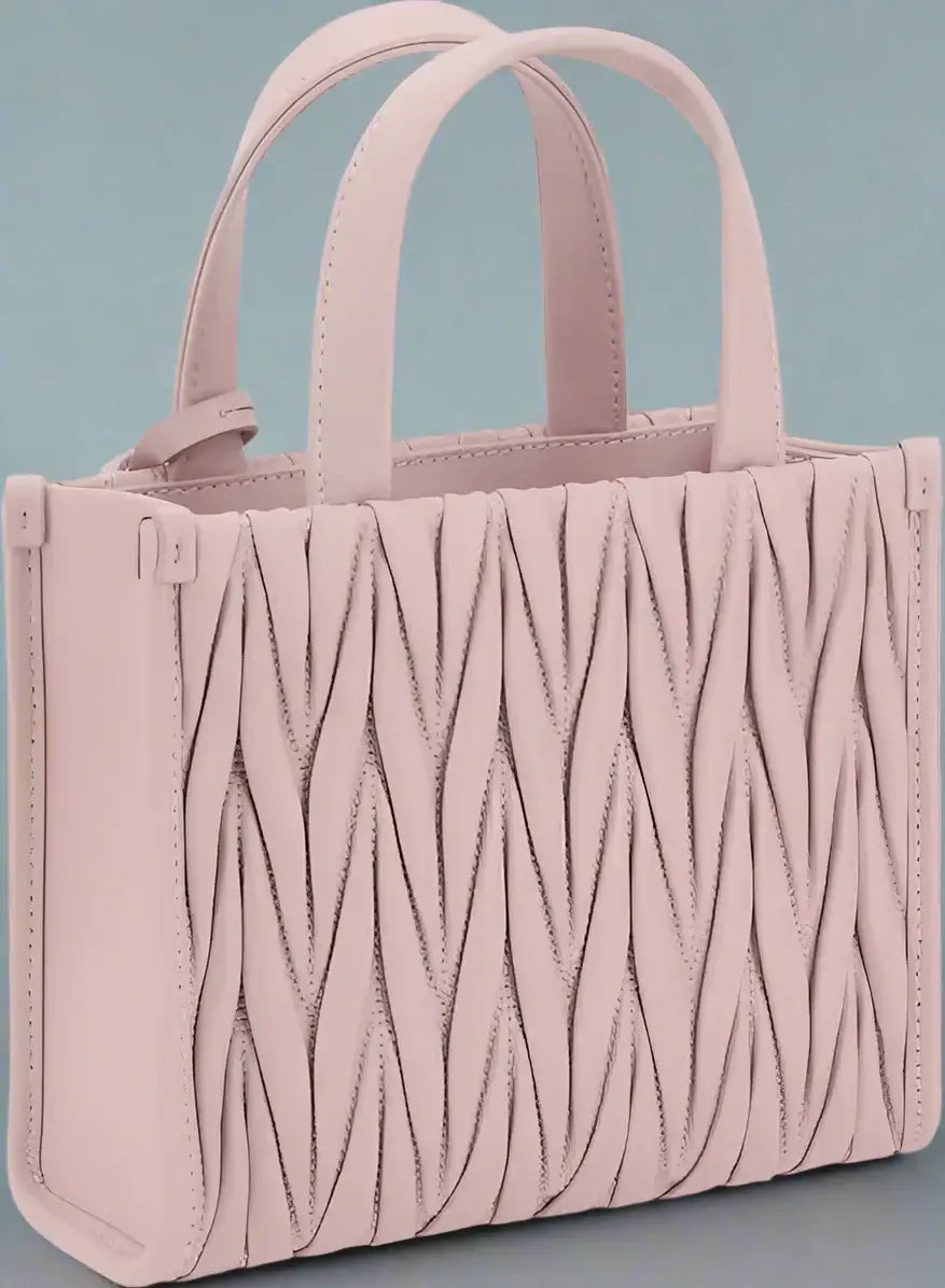 Pink textured handbag with handles on a white background