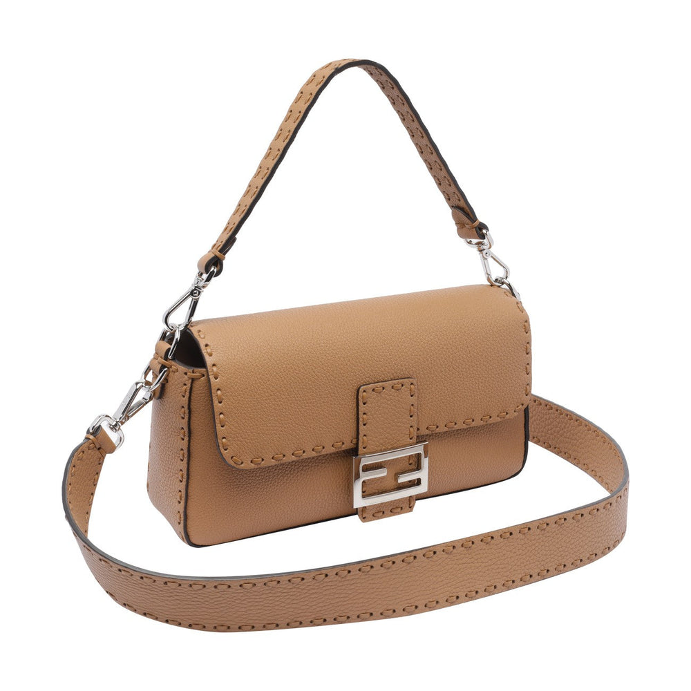Brown handbag with a strap on a white background