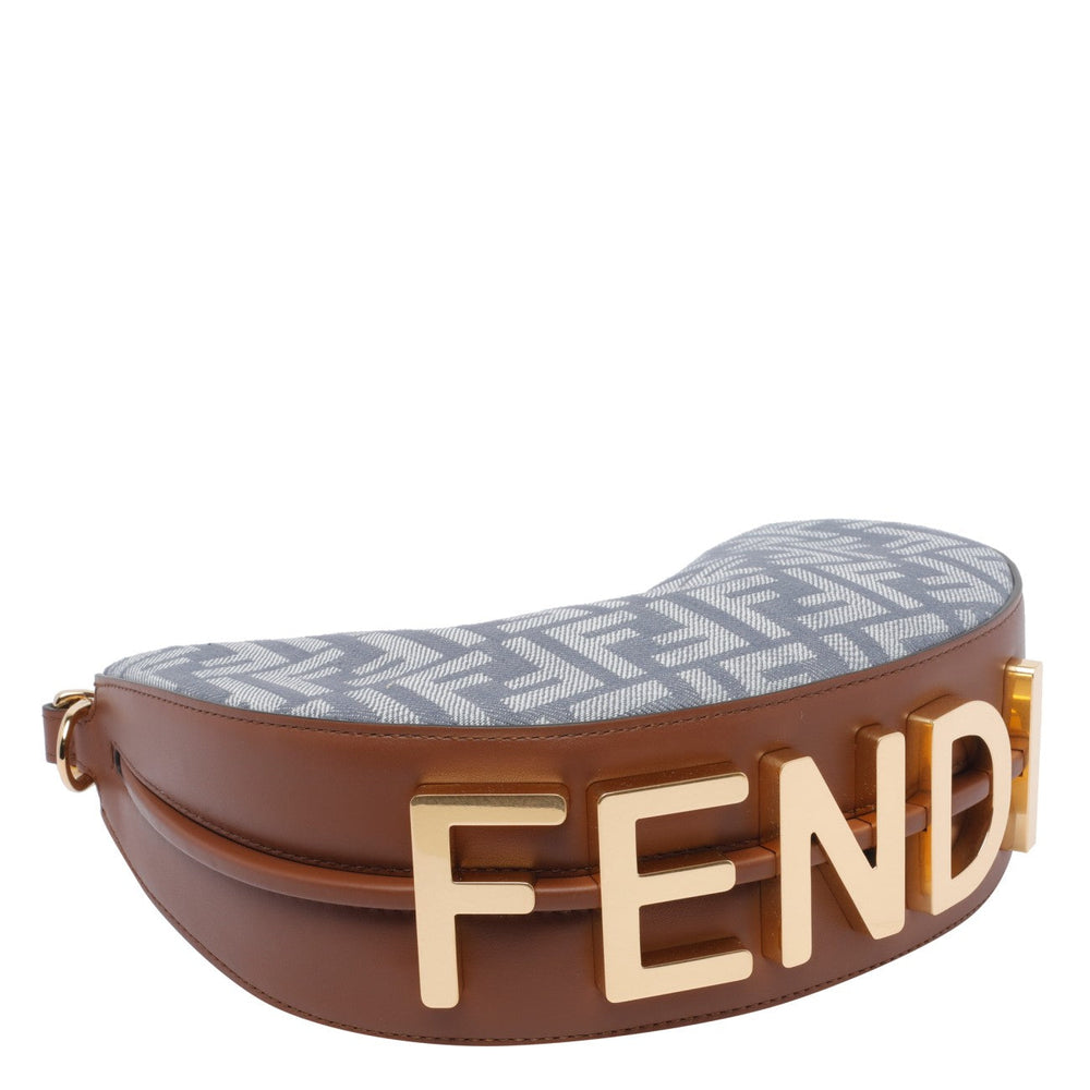 Brown and gold Fendi clutch with patterned interior on a white background