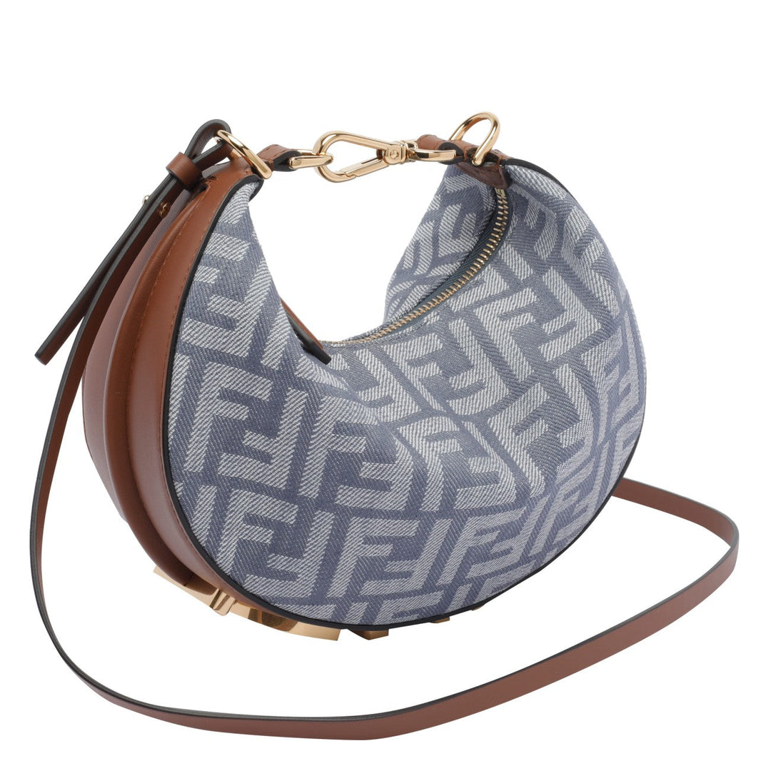 Designer handbag with a patterned flap and brown strap on a white background