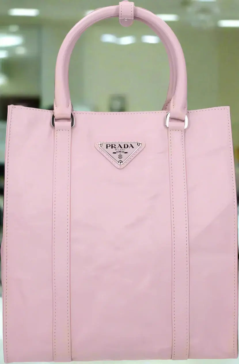 Pink Prada handbag on a white background