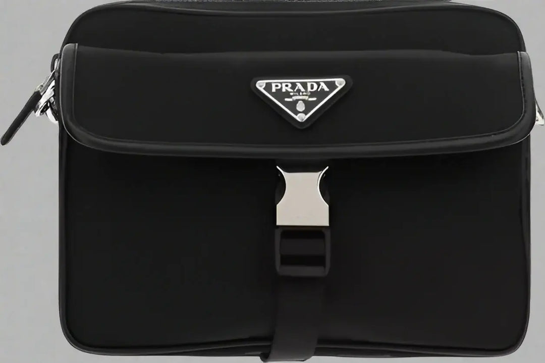 Black Prada bag with a silver buckle on a white background
