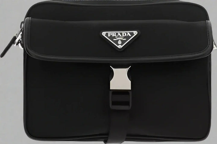 Black Prada bag with a silver buckle on a white background