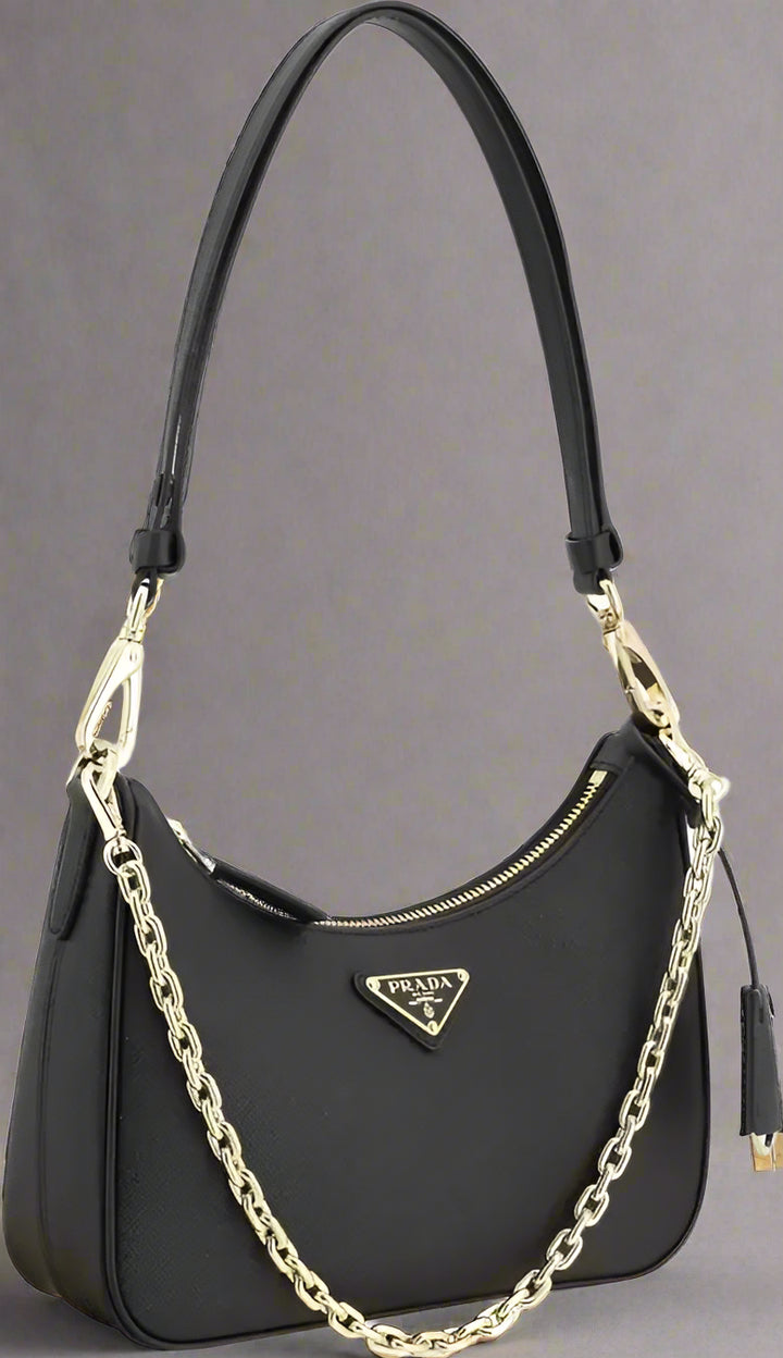 Black handbag with gold chain and Prada logo on a white background