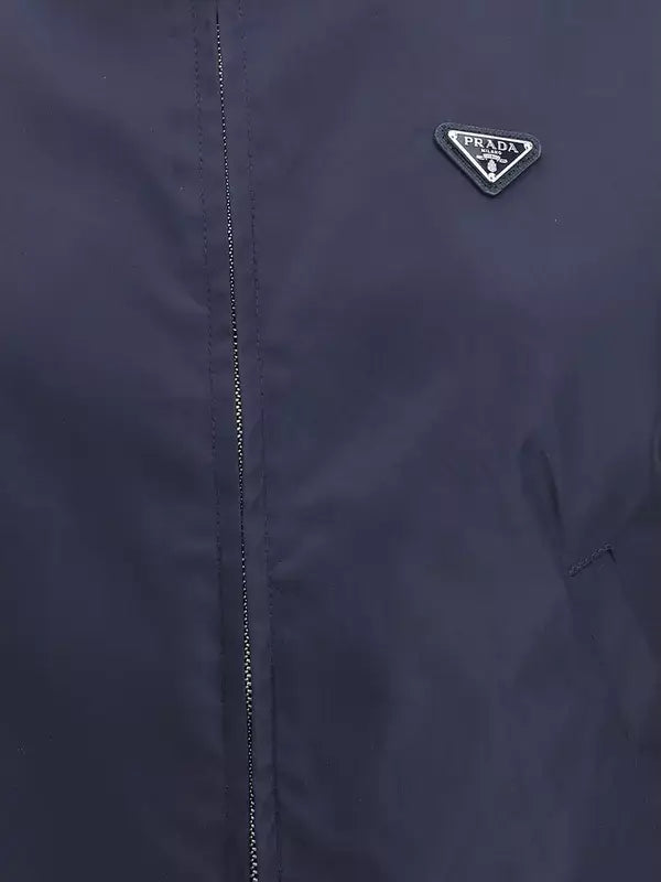 Navy blue jacket with Prada logo on a dark background
