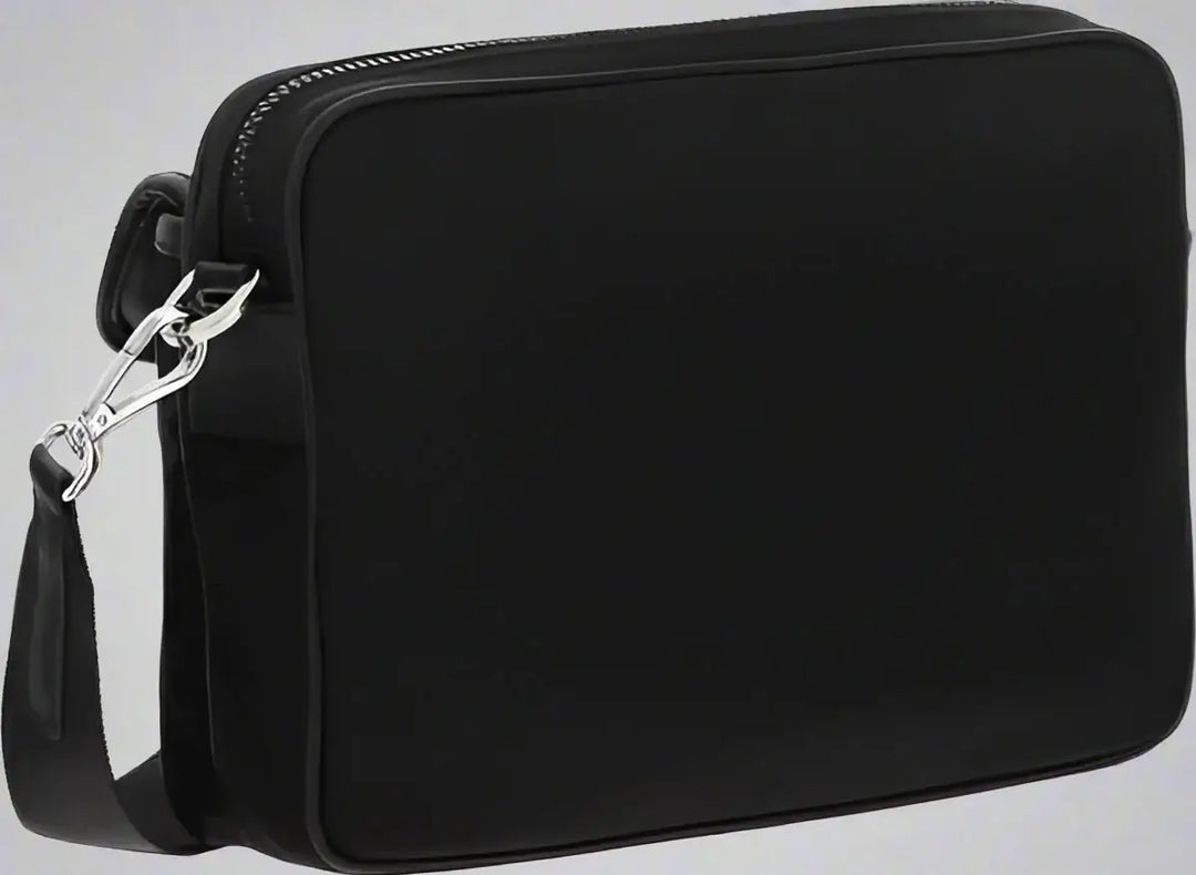 Black crossbody bag with a strap on a white background