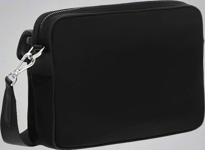 Black crossbody bag with a strap on a white background