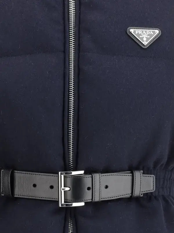 Navy blue jacket with a Prada logo and black belt on a dark background