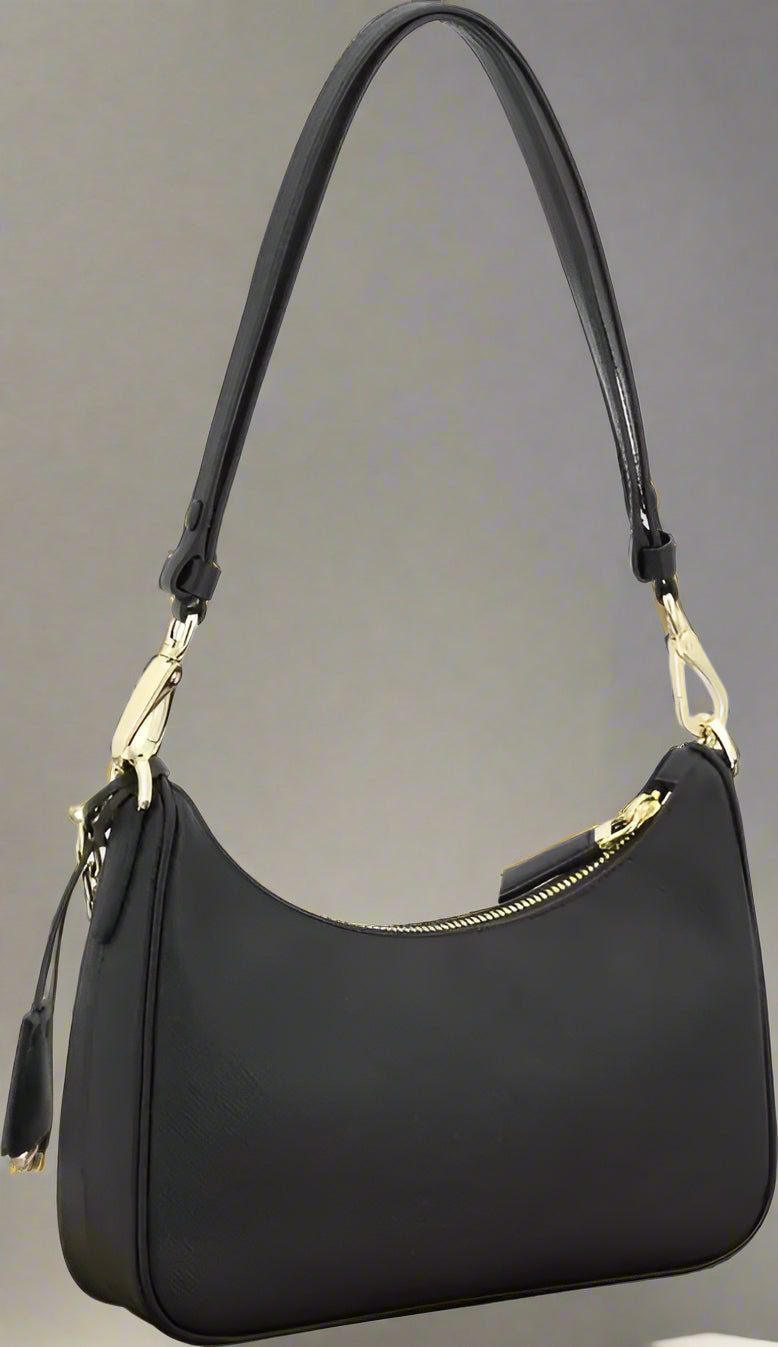 Black handbag with gold accents on a white background