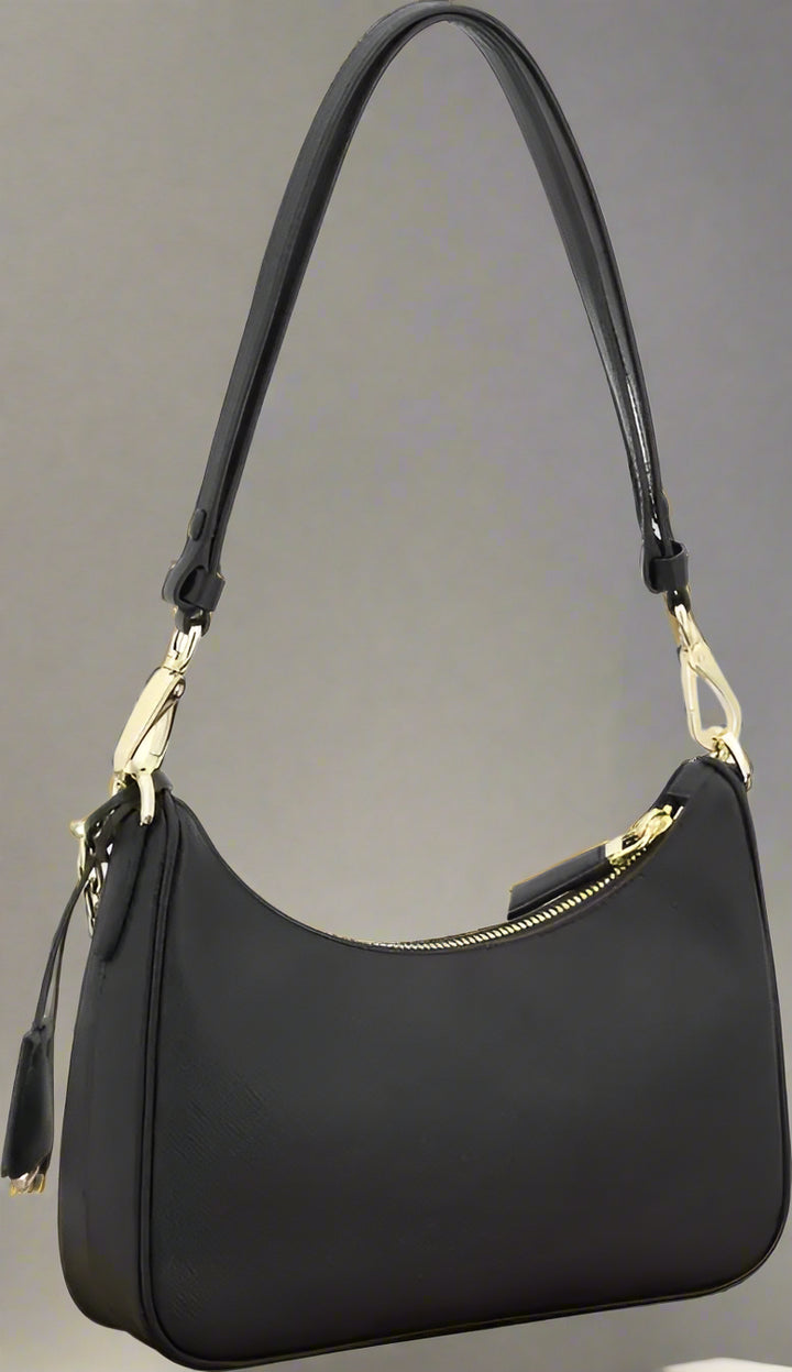 Black handbag with gold accents on a white background