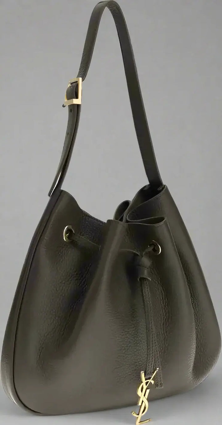 Black leather handbag with drawstring and gold hardware on a white background