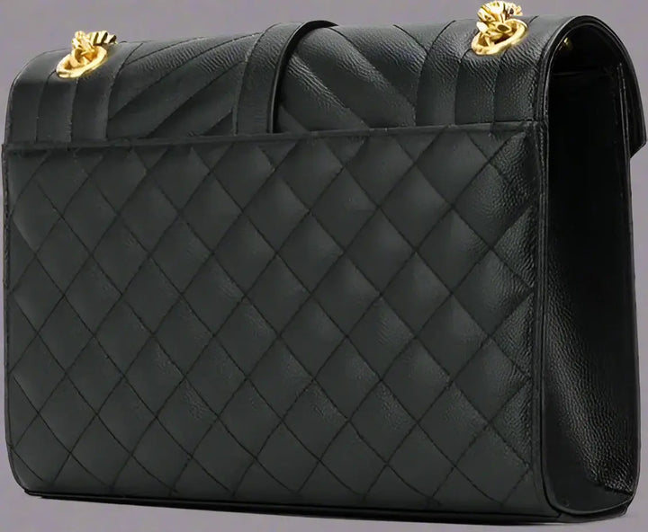 Black quilted handbag with gold hardware on a white background