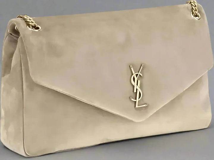 Beige handbag with gold chain and logo on a white background