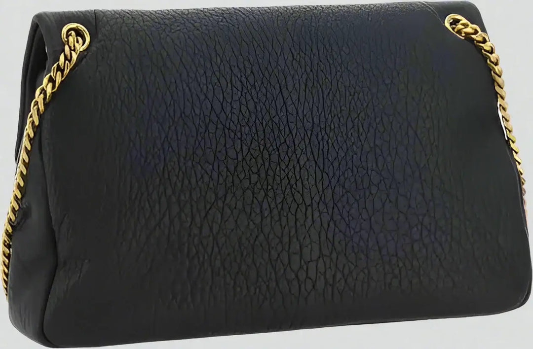 Black textured handbag with gold chain strap on a white background