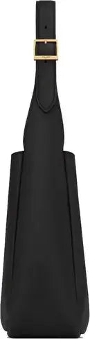 Black shoulder bag with a gold buckle on a black background
