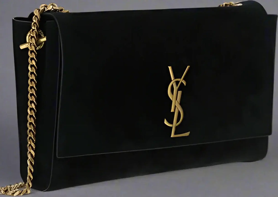 Black handbag with gold chain and logo on a white background