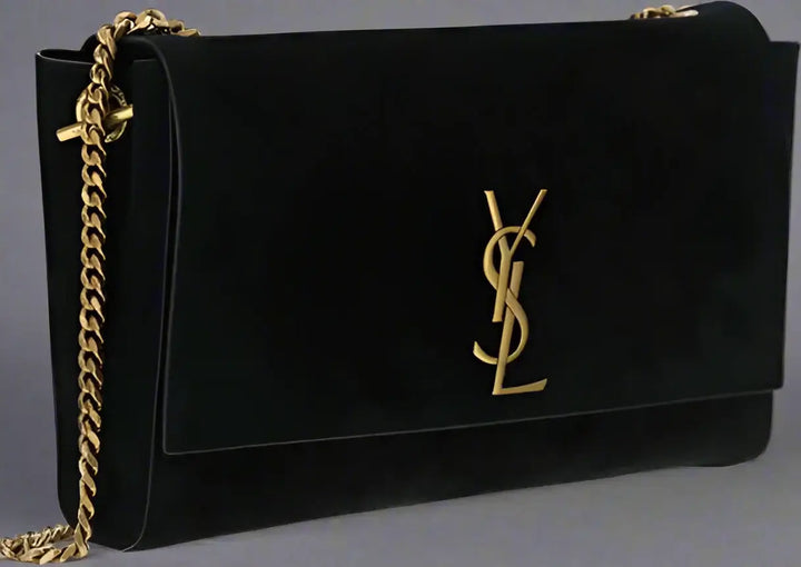 Black handbag with gold chain and logo on a white background