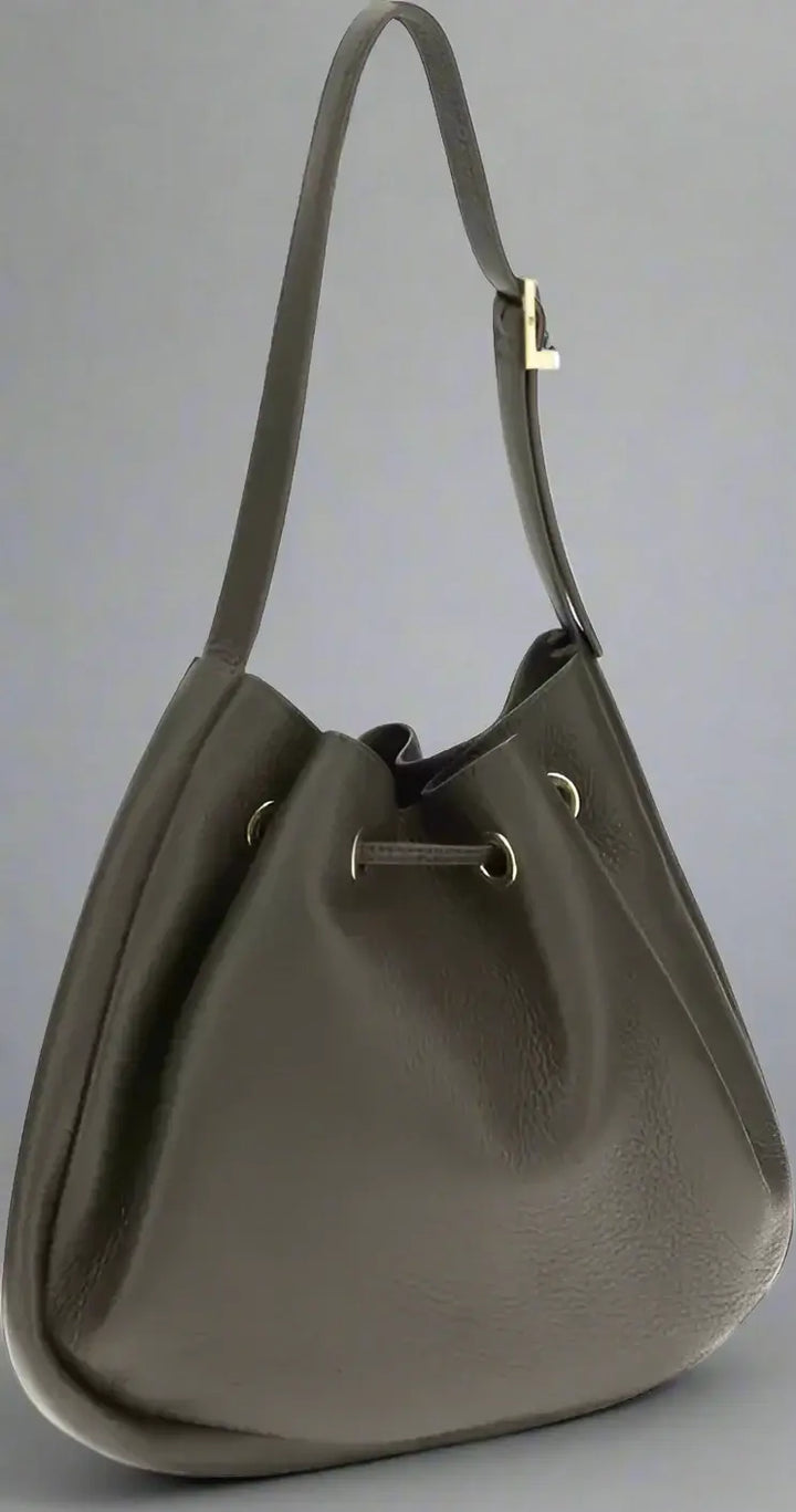 Dark brown leather handbag with a drawstring on a white background
