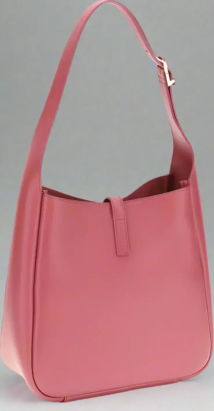 Pink handbag with a shoulder strap on a white background