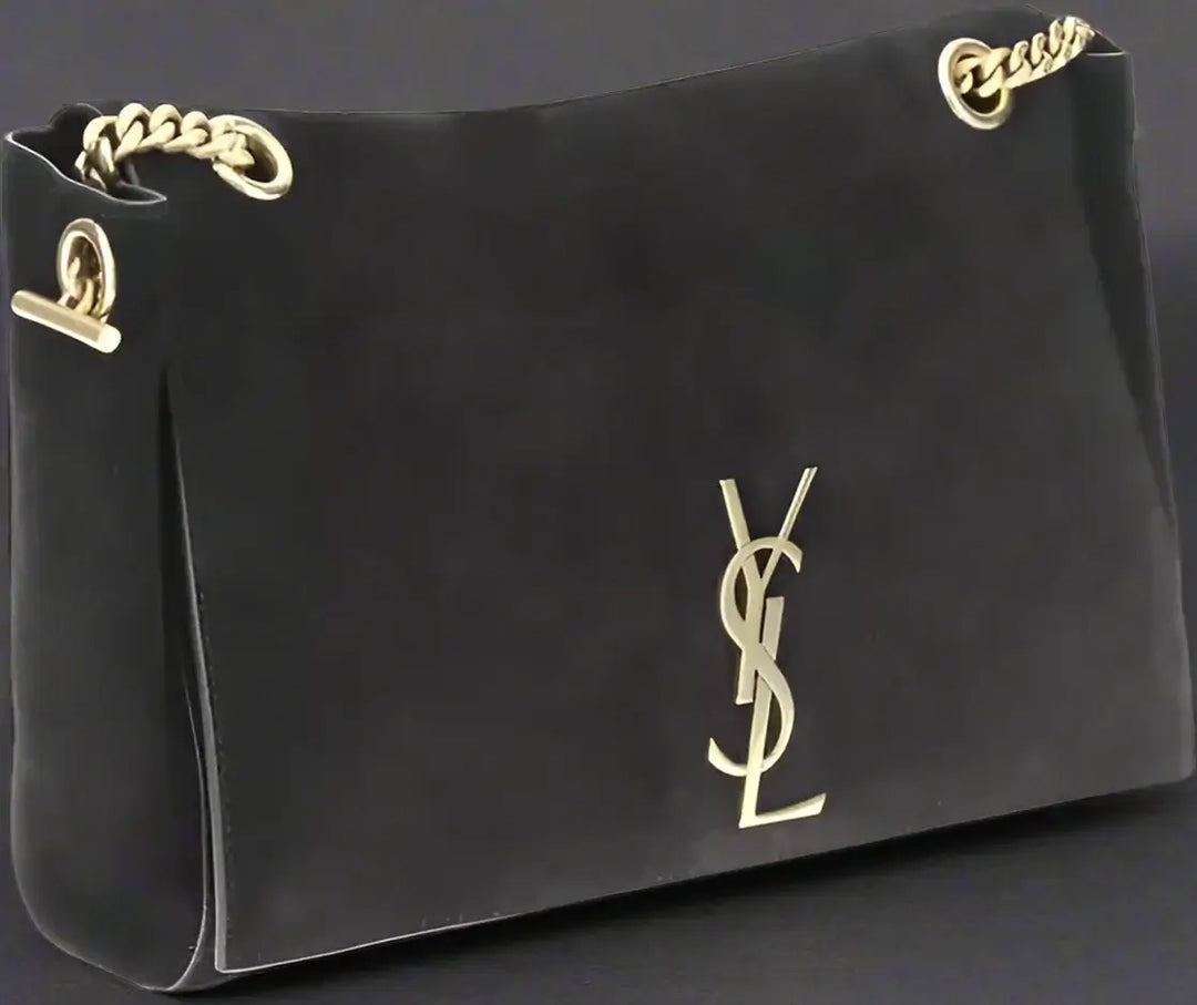 Black handbag with gold chain and logo on a white background