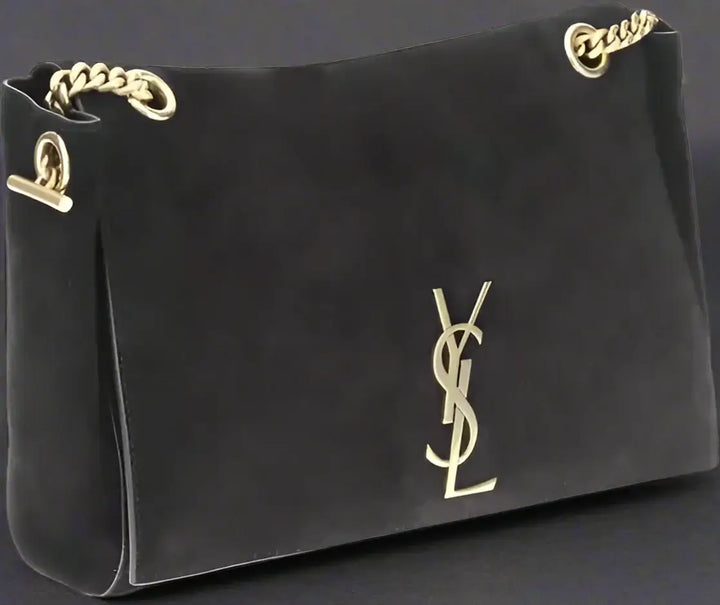 Black handbag with gold chain and logo on a white background