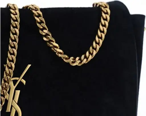 Gold chain necklace on a black background