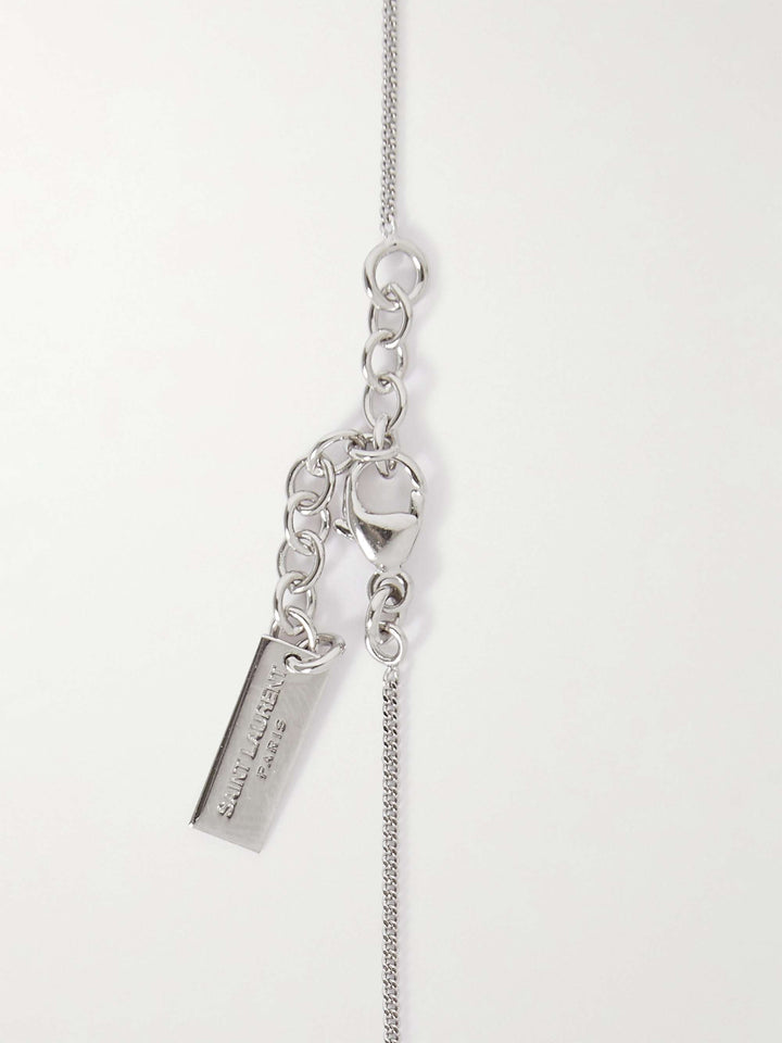 Silver necklace with pendant on a light gray background