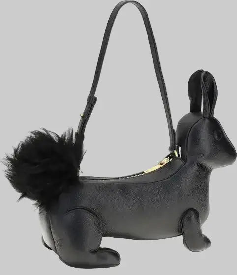 Black squirrel-shaped handbag with a fluffy tail on a white background