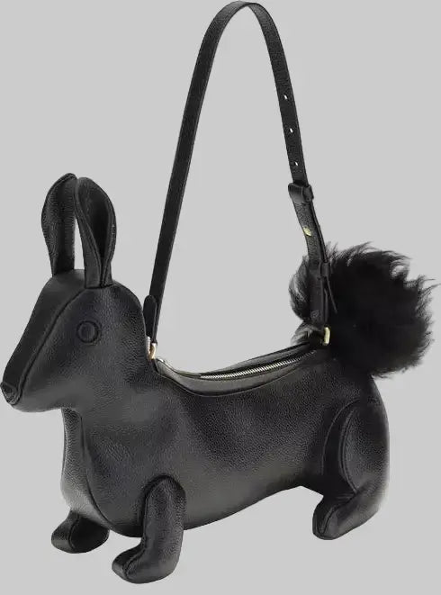 Black dachshund-shaped handbag with a fluffy tail on a white background