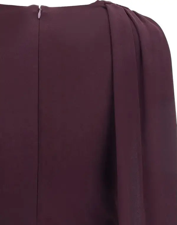 Close-up of a burgundy fabric with a subtle pattern on a white background