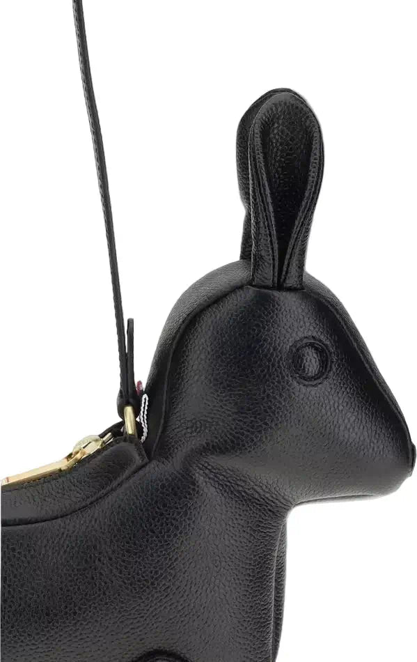 Black rabbit-shaped handbag with a gold zipper on a white background