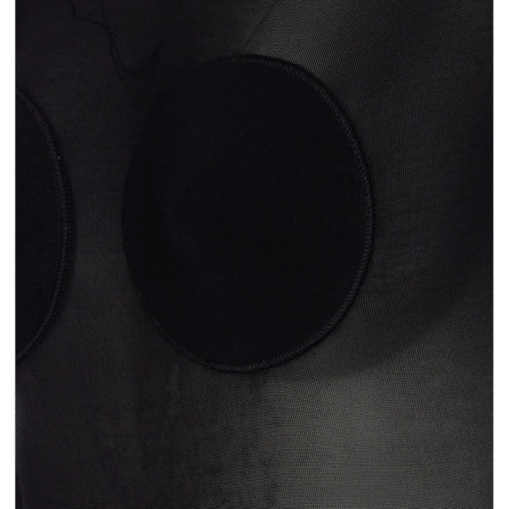 Close-up of a black circular object on a textured black surface