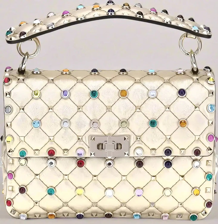 Quilted handbag with colorful gemstones and a brand logo on a white background