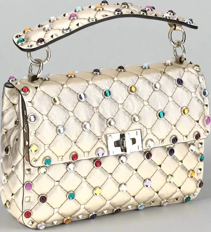 Quilted handbag with colorful gemstones and a brand logo on a white background