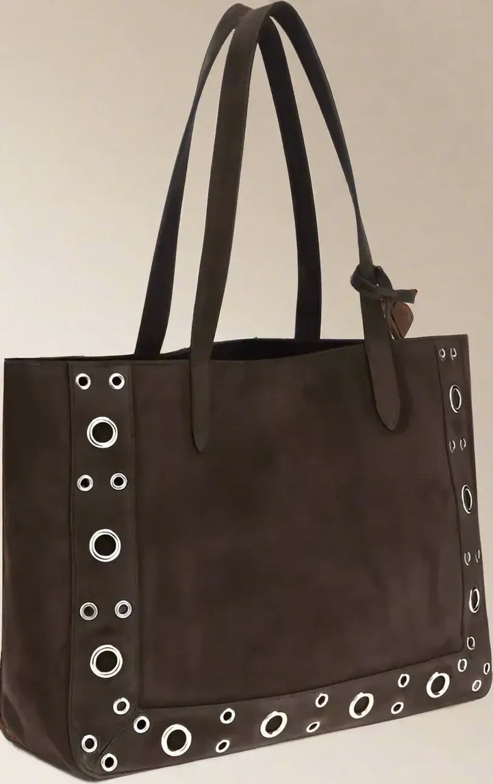 Brown tote bag with grommet details on a white background